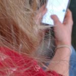 A woman in the theatre checking her phone