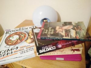 A stack of books on a bedside table